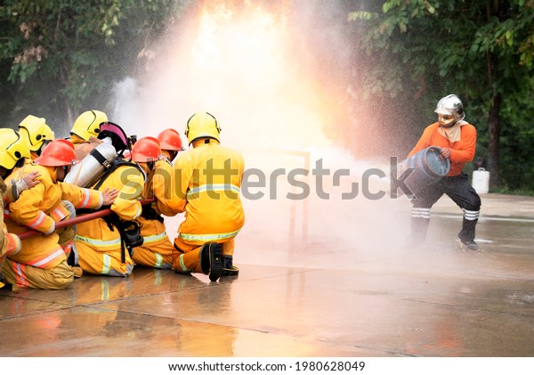 Firefighters train firefighters to use water and\
fire extinguishers to fight flames in emergency situations.Under\
dangerous situations, all firefighters wear a firefighter\'s\
clothing for\
safety.