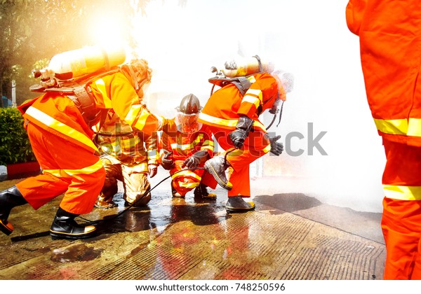 Firefighters are training\
firefighting methods for industrial workers. In Samut Sakhon,\
Thailand,\
4-11-2017