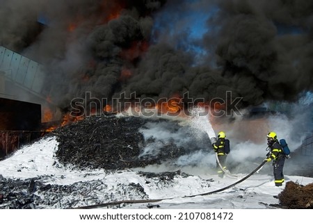 Firefighters use foam to extinguish a massive fire of large amounts of plastic waste
 Foto stock © 