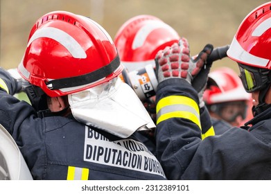 Firefighters using hydraulic tools during a rescue operation training. Rescuing the passenger in car after accident. High quality photography.