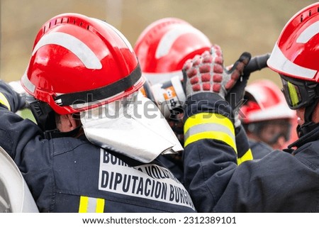 Firefighters using hydraulic tools during a rescue operation training. Rescuing the passenger in car after accident. High quality photography.