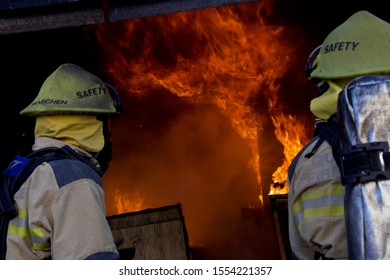 Firefighters Watching As Fire Takes House