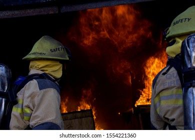 Firefighters Watching As Fire Takes House