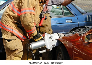 Firefighters Work On An Extrication Using A Hydraulic Rescue Tool