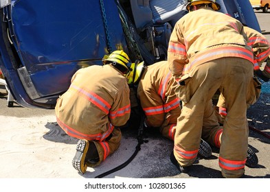 Firefighters Work On An Extrication Using A Hydraulic Rescue Tool