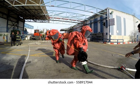 Firefighters From Zvulun Practice Sealing Of Leak Accident From Corrosive Toxic Hazardous Material Ammonia Liquid Container In Food Factory Dressing Protective Suites. Akko, Israel, DEC 17th, 2016