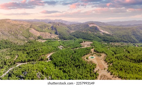 Firefighting artificial pond with water in mountain forest. Aerial view - Shutterstock ID 2257993149