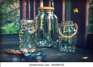 Fireflies in jars in a tree house, with magnifying glass. Long exposure, focus on top of jar on the left