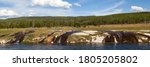 The Firehole River with water from nearby hot springs flowing over the embankment and into the river at Yellowstone National Park, Wyoming.