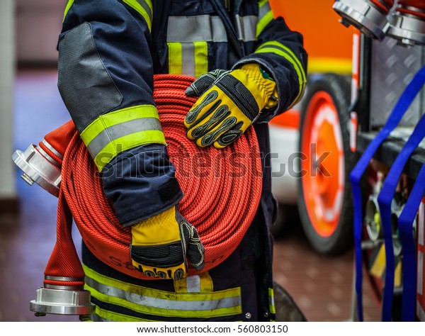 Fireman Action Rolled Fire Hose On Stock Photo Edit Now 560803150