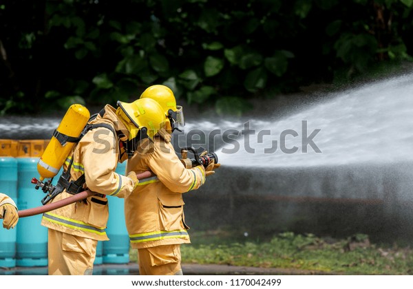 Fireman Attacking Fire Water Firefighter Team Stock Photo 1170042499 ...