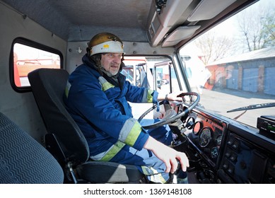 Fireman Driver Sitting In A Cabin Of A Firetruck Holding A Wheel Before Training.  April 5, 2019. Forestry Of Sviatoshyn District, Kievskaya Oblast, Ukraine