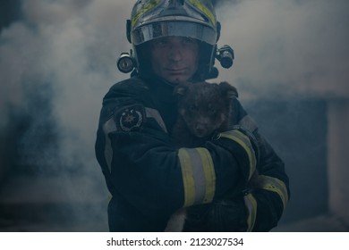 Fireman in equipment holding a dog