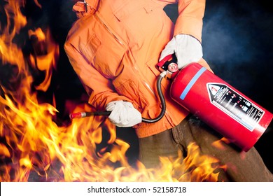 Fireman With Extinguisher Fighting A Fire