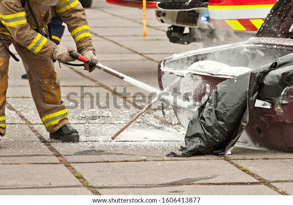 The fireman extinguishes the\
burned car. Training firefighters. Demonstration rescue\
work.