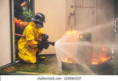 Fireman In Fire Fighting And Evacuation Fire Drill Simulation Training For Safety In Condominium Or Factory