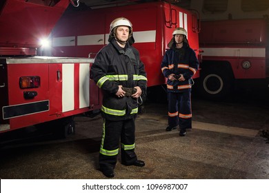 Fireman (firefighter) in action standing  near a firetruck. Emergency safety. Protection, rescue from danger. - Shutterstock ID 1096987007