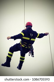 Fireman Hanging From A Cord Suspended During An Exercise With Vintage Effect