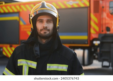 fireman in protective uniform standing near fire engine on station. - Powered by Shutterstock