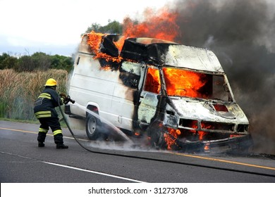 Fireman Putting Out Van That Is Burning