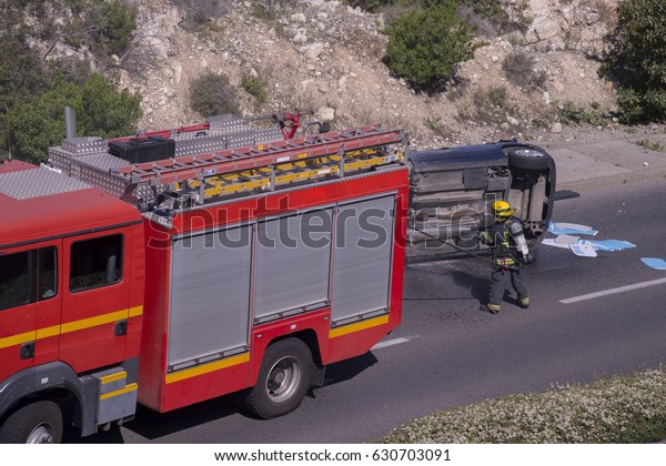Fireman at the scene of a car accident the uphill\
entrance road to the Carmel neighborhoods in Haifa on the April.15\
2017, Israel