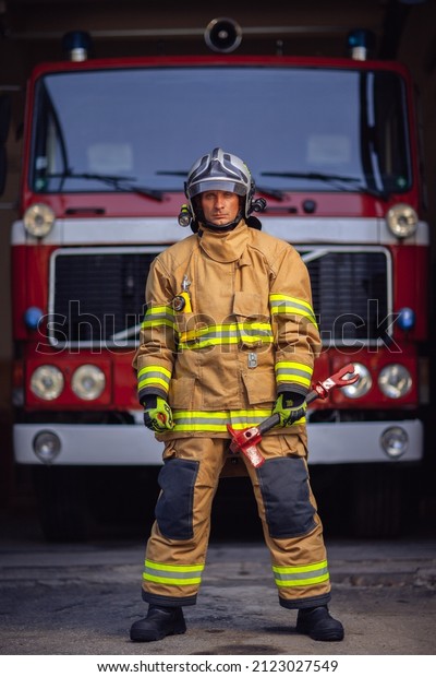 Fireman in uniform stands by\
the car