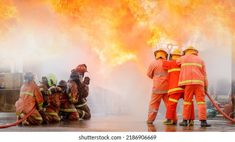 Fireman,Firefighter Training Firefighters Using Water And Fire Extinguishers To Fight The Flames In Emergency Situations. In A Dangerous Situation All Firefighters Wear Firefighter Uniforms For Safety