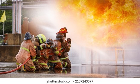 Fireman,Firefighter Training Firefighters Using Water And Fire Extinguishers To Fight The Flames In Emergency Situations. In A Dangerous Situation All Firefighters Wear Firefighter Uniforms For Safety