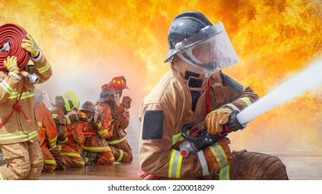 Fireman,Firefighter Training Firefighters Using Water And Fire Extinguishers To Fight The Flames In Emergency Situations. In A Dangerous Situation All Firefighters Wear Firefighter Uniforms For Safety