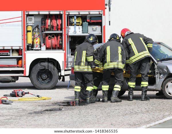 firemen in action\
after the car road\
accident