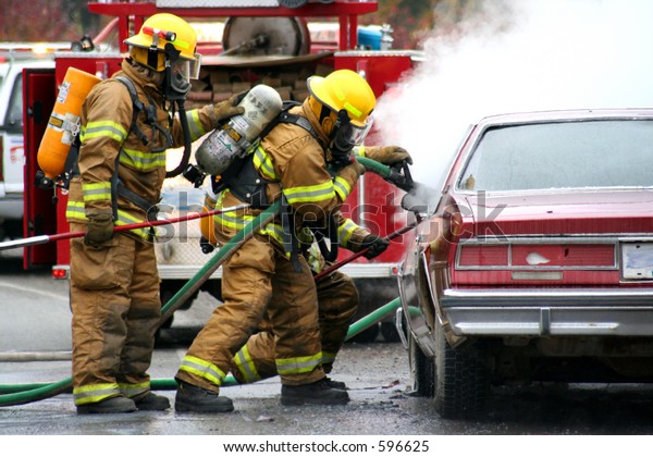 firemen with burning\
car