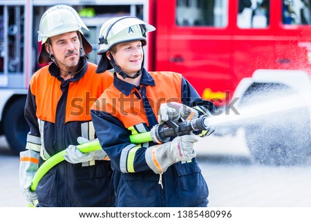 Firemen of the fire department extinguish fire