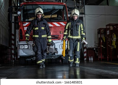 Firemen Leaving The Station Equipped And With The Tools For The Extinction Of The Fire