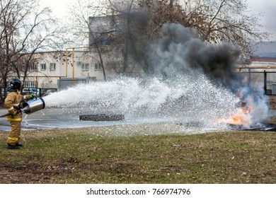 Firemen Pouring Flame With Firefighting Foam