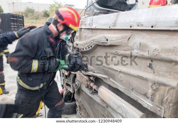 Firemen practicing techniques of rescue of
victims in traffic accidents with
tools