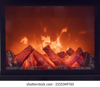 Fireplace With Bright Flames. Artificial Decorative Fireplace With Imitation Of Fire. Modern Home Comfort Technology. Full Screen Photo. Front View.