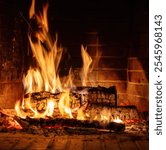 Fireplace burning, wood logs and bright flames. Warm home in winter, heat. Christmas holiday