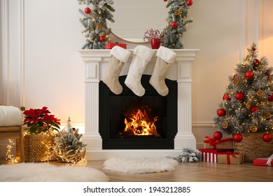 Fireplace with Christmas stockings in beautifully decorated living room - Powered by Shutterstock