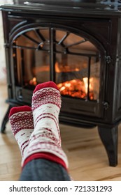 Fireplace Cozy Winter Woman Warming Up Feet In Wool Socks By Fire In After Ski Cabin House. Closeup Or Warm Fire And Cute Legs During Cold Season.