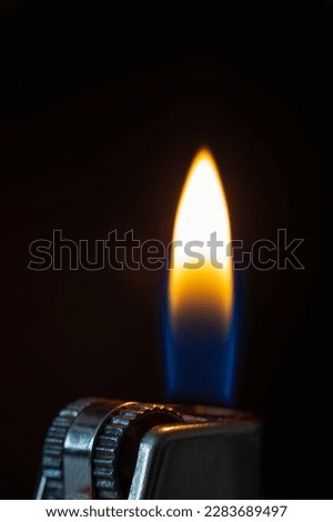 Firestarter with fire on black background. Macro photo on black
