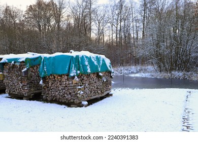 Firewood along a frozen flow in Spree Forest, winter wonderland, Germany - Powered by Shutterstock