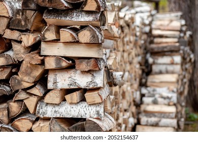 firewood background of chopped wood for kindling and heating the house Close-up. a woodpile with stacked firewood. the texture of the birch tree. banner