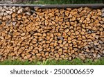 Firewood background. Firewood stack. Stacked split logs. Woodpile. Firewood for winter.