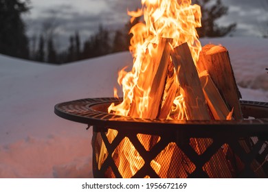 Firewood chopped up for a perfectly created firepit in the snow of Fairbanks Alaska