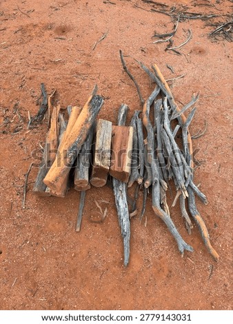 Firewood Stack On Red Outback Soil With Copy Space
