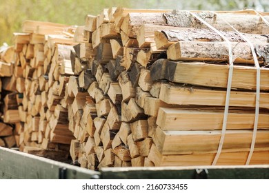 Firewood for the winter. Firewood Background, Stacks of Firewood in car. Pile of Firewood.