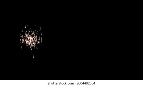 A firework explodes in the night sky on July 4.