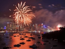 Firework In Sydney New Year Eve Event Celebration Bright Pyrotechnic Lights Reflect In Harbor Water Over City CBD