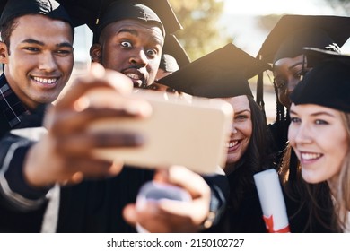 The Fireworks Begin Today. Shot Of A Group Of Students Taking Selfies With A Mobile Phone On Graduation Day.