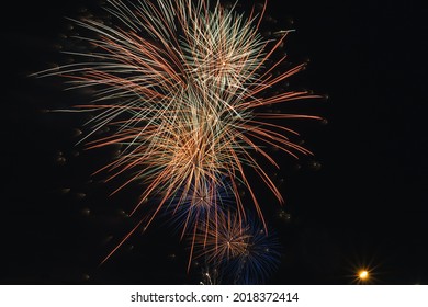 Fireworks Of Different Colors In The Middle Of The Night In The Middle Of The Night On A Celebrity Holiday, Event Or Country Fair And Selective Focus